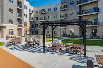 Outdoor grilling patio with tables and seating